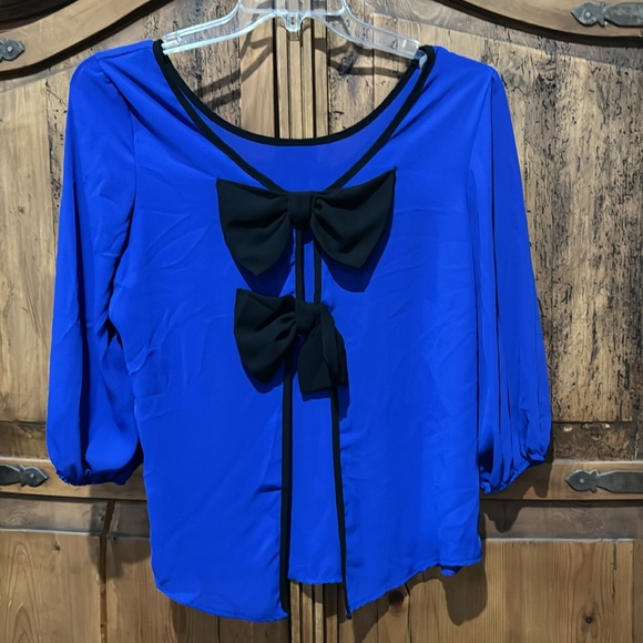 Sheer bright blue top with black bows on back. It’s a large by Agaci. - Picture 4 of 5